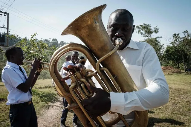 Brass band members perform as they enter before the launch of the extension of the world’s first malaria vaccine (RTS, S) pilot program for children at risk of malaria illness and death within Kenya’s lake-endemic region at Kimogoi Dispensary in Gisambai on March 7, 2023. The pilot program coordinated by the World Health Organization (WHO) has provided malaria vaccines in three countries, Ghana, Malawi and Kenya, since 2019. More than 1.2 million children under five years old have received at least one dose of the four-dose vaccine in Africa. According to the WHO, the vaccine has been estimated to save one child's life for every 200 children vaccinated. Around 90 percent of the world's malaria cases are recorded in Africa, where 260,000 children die from the disease each year. (Photo by Yasuyoshi Chiba/AFP Photo)