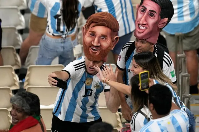 Argentinian fans cheer up as they arrive for the World Cup quarterfinal soccer match between the Netherlands and Argentina, at the Lusail Stadium in Lusail, Qatar, Friday, December 9, 2022. (Photo by Thanassis Stavrakis/AP Photo)