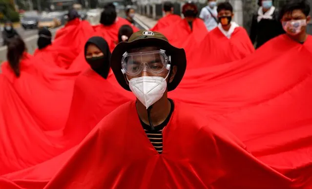 Youth activists wearing red cloth take part in a protest during the Asia Climate Rally, outside the Indonesian Ministry of Energy and Mineral Resources in Jakarta, Indonesia, November 27, 2020. (Photo by Willy Kurniawan/Reuters)