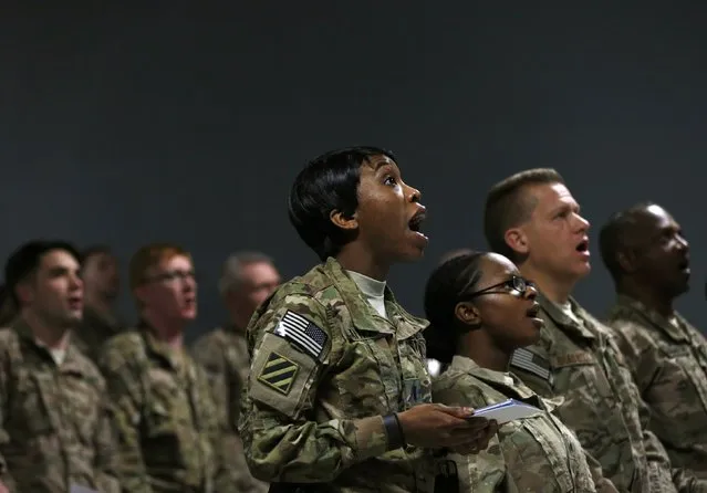U.S. troops from the Nato-led International Security Assistance Force sings Christmas carols during a Christmas Eve celebrations at Bagram Airfield, north of Kabul, December 24, 2014. (Photo by Mohammad Ismail/Reuters)