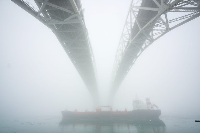 A ship makes its way down the St. Clair River under the Blue Water Bridge border crossing between Sarnia, Ontario and Port Huron, Michigan on February 3, 2025. (Photo by USA Today)