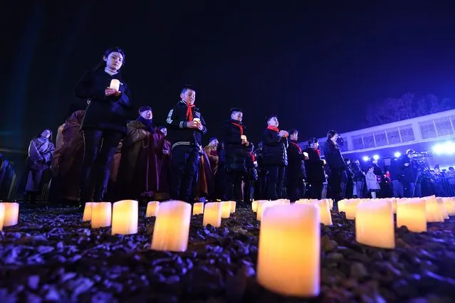 People take part in a candlelight vigil in commemoration of victims of the Nanjing Massacre on the occasion of the seventh national memorial day at the Memorial Hall of the Victims of the Nanjing Massacre by Japanese Invaders in Nanjing, capital of east China's Jiangsu Province, December 13, 2020. (Photo by Li Bo/Xinhua via Getty Images)