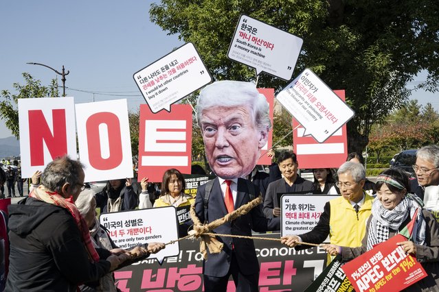 Anti-Trump activists stage a protest in front of Guhwanggyo Bridge in Gyeongju on the 29th, opposing U.S. President Donald Trump's visit to South Korea on October 29, 2025. The protesters denounced Trump's remarks and criticized what they called economic exploitation through tariffs, displaying red papers inscribed with anti-Trump slogans. (Photo by Suh Jeen Moon/Zuma Press/Rex Features/Shutterstock)