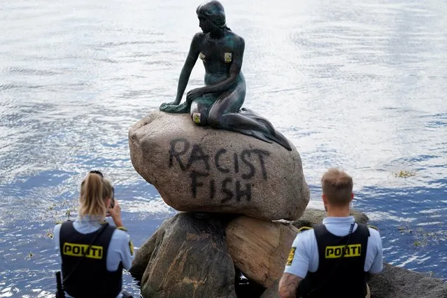 Danish police officers take pictures of the base of the Little Mermaid statue (Den lille Havfrue) after it was vandalised on July 3, 2020. (Photo by Mads Claus Rasmussen/Ritzau Scanpix/AFP Photo)