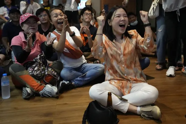 Supporters of Move Forward party cheer as they watch counting of votes on television at Move Forward Party headquarters in Bangkok, Thailand, Sunday, May 14, 2023. Vote counting was underway Sunday in Thailand's general election, touted as a pivotal chance for change nine years after incumbent Prime Minister Prayuth Chan-ocha first came to power in a 2014 coup. (Photo by Sakchai Lalit/AP Photo)