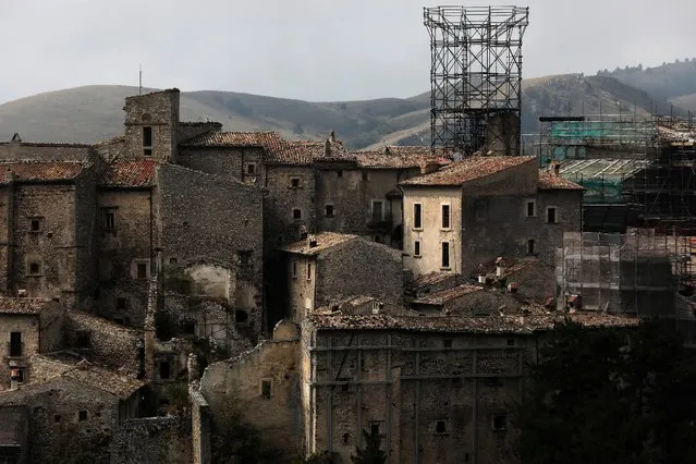 Metal frames support what is left of a medieval tower, as works are in progress to reconstruct it after it collapsed in the 2009 earthquake, in Santo Stefano di Sessanio in in the province of L'Aquila in Abruzzo, inside the national park of the Gran Sasso e Monti della Laga, Italy, September 22, 2016. (Photo by Siegfried Modola/Reuters)