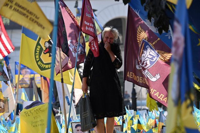 A woman grieves as she visits a designated area for commemorating fallen Ukrainian soldiers at the Independence Square in Kyiv on August 29, 2024, during the Remembrance Day of Defenders of Ukraine. (Photo by Sergei Supinsky/AFP Photo)