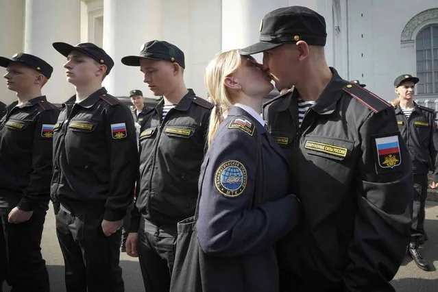 A Russian conscript kisses his partner during a send-off event before they head to assigned military units for mandatory one-year military service, in St. Petersburg, Russia, Tuesday, May 23, 2023. Russian President Vladimir Putin has signed a decree to enroll 147,000 conscripts aged 18-27 into the army during spring draft. Those drafted will do one year of mandatory military service. (Photo by Dmitri Lovetsky/AP Photo)