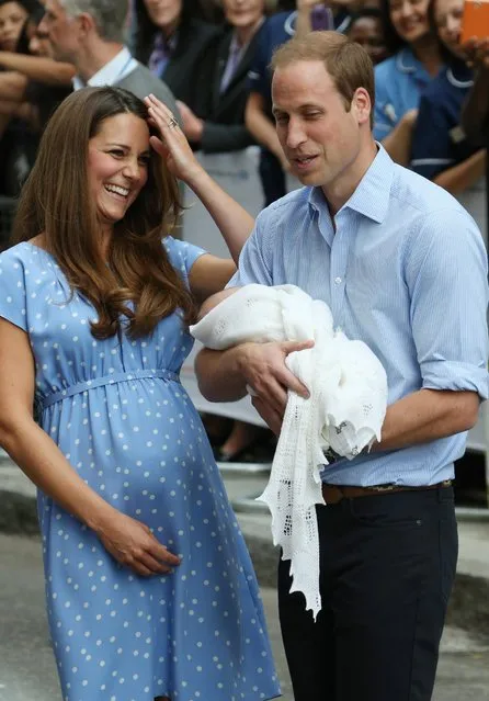 Britain's Prince William, right, and Kate, Duchess of Cambridge hold the Prince of Cambridge, Tuesday July 23, 2013, as they pose for photographers outside St. Mary's Hospital exclusive Lindo Wing in London where the Duchess gave birth on Monday July 22. The Royal couple are expected to head to London's Kensington Palace from the hospital with their newly born son, the third in line to the British throne. (Photo by Joel Ryan/Invision/AP)