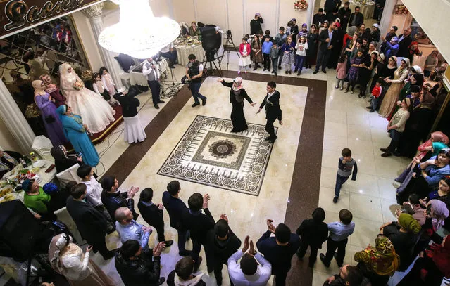 Guests dance during a traditional Chechen wedding ceremony in Grozny, Chechnya, Russia on November 24, 2016. (Photo by Valery Sharifulin/TASS)