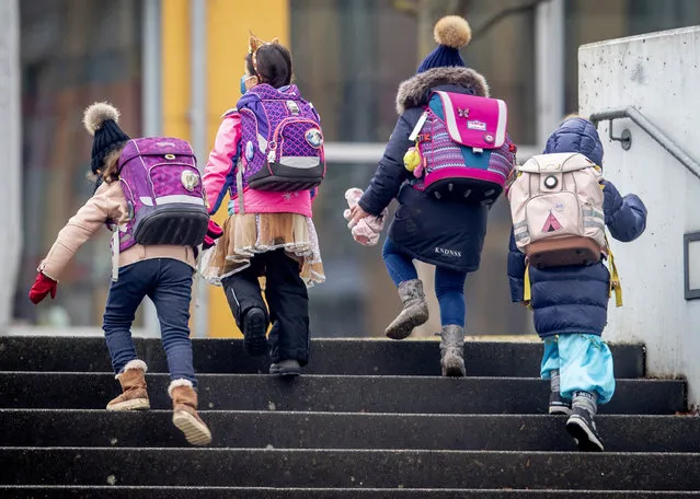 In this February 16, 2021 file photo,Pupils go to school in Frankfurt, Germany. Amid pressure to relax the lockdown, Germany agreed last month to gradually begin reopening schools. Then coronavirus cases started climbing again, prompting authorities in some regions to put those plans on hold even as others press on and insist that in-class teaching needs to be the norm. (Photo by Michael Probst/AP Photo/ile)