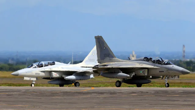 A FA-50 fighter jet (L), newly purchased from South Korea, is escorted by a fighter jet upon arrival at a Hangar in Clark air base, Angeles city, Pampanga province, north of Manila, Philippines December 1, 2016. (Photo by Romeo Ranoco/Reuters)
