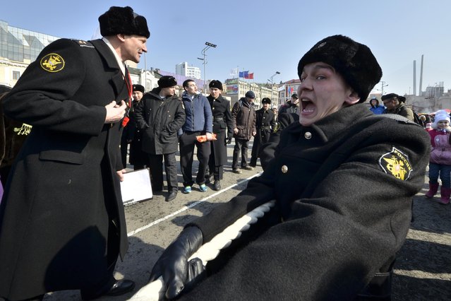Russian navy sailors participate in a tug-of-war competition during celebrations for the Defender of the Fatherland Day in the far eastern city of Vladivostok February 23, 2015. (Photo by Yuri Maltsev/Reuters)