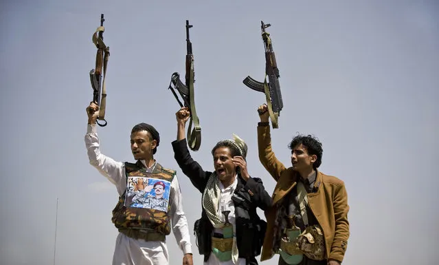 Supporters of Ahmed Ali Abdullah Saleh, the son of Yemeni former President Ali Abdullah Saleh, hold their weapons as they chant slogans during a demonstration demanding presidential elections be held and the younger Saleh run for the office, in Sanaa, Yemen, Tuesday, March 10, 2015. (AP Photo/Hani Mohammed)