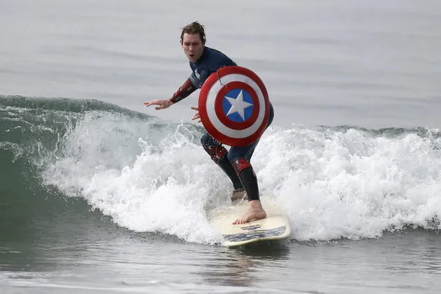 A man competes dressed as “Captain America” during the ZJ Boarding House Halloween Surf Contest in Santa Monica, California October 26, 2013. (Photo by Lucy Nicholson/Reuters)