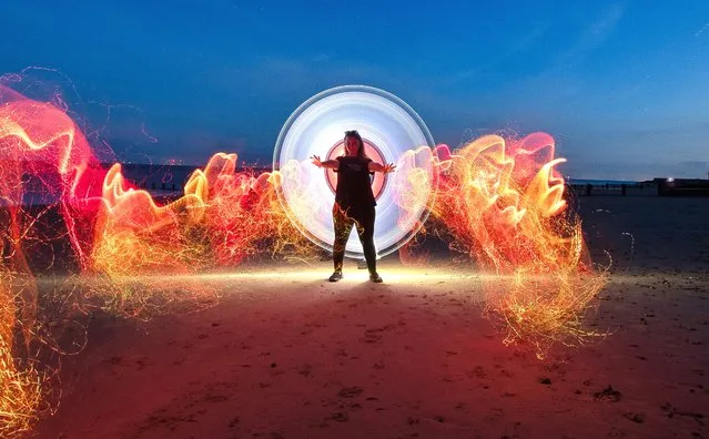 Light painting on the beach at Frinton-on-Sea in Essex, UK using LED lights during a 23-second exposure, with model Sarah Jane Denham posing on September 13, 2023. (Photo by Kevin Jay/Picture Exclusive)