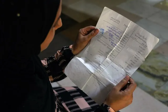 Syrian refugee Sarah Jassem Mohammed holds the death certificate of her five-month-old son Qusai, who was killed in the 2020 Beirut port explosion in Markabta, near Tripoli, Lebanon, Wednesday, July 26, 2023. Three years after the blast, some victims have not been listed, including Qusai. Naming Qusai would make him the blast's youngest victim and allow his family, refugees from Syria, to seek compensation. (Photo by Bilal Hussein/AP Photo)