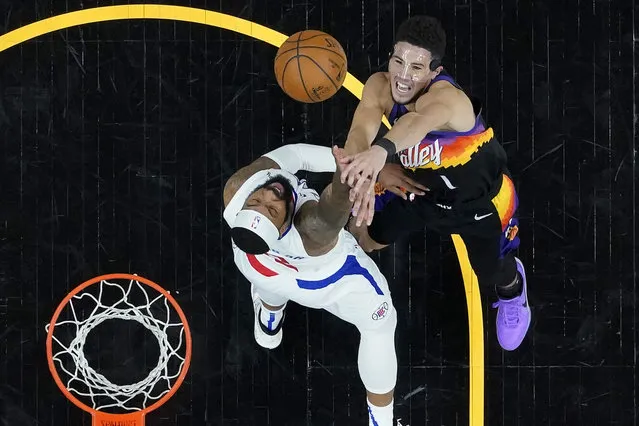 Phoenix Suns guard Devin Booker (1) shoots over Los Angeles Clippers forward Marcus Morris Sr. during the second half of game 5 of the NBA basketball Western Conference Finals, Monday, June 28, 2021, in Phoenix. (Photo by Matt York/AP Photo)
