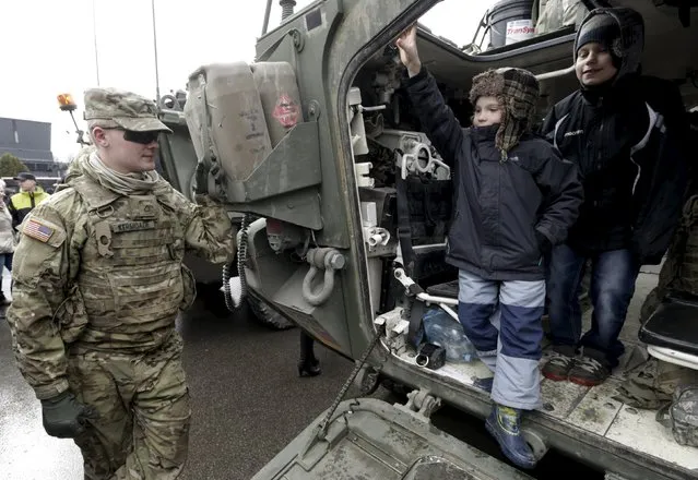 Children leave a “Stryker” armored fighting vehicle of the U.S. Army 2nd Cavalry Regiment, who is deployed in Estonia as a part of the U.S. military's Operation Atlantic Resolve, during the “Dragoon Ride” exercise in Parnu March 21, 2015. Operation Atlantic Resolve is aimed at demonstrating commitment to NATO allies in light of Russia's aggression in Ukraine, according to the U.S. Army. (Photo by Ints Kalnins/Reuters)