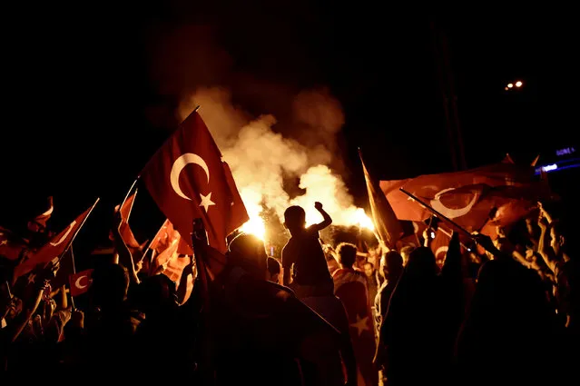 Pro-Erdogan supporters wave Turkish national flags during a rally at Taksim square in Istanbul on July 18, 2016 following the military failed coup attempt of July 15. Turkish security forces on July 18 carried out new raids against suspected plotters of the botched coup against the rule of President Recep Tayyip Erdogan, as international concern grew over the scale of the crackdown. Thousands of pro-Erdogan supporters waving Turkish flags filled the main Kizilay Square in Ankara while similar scenes were seen in Taksim Square in Istanbul, AFP photographers said. (Photo by Aris Messinis/AFP Photo)