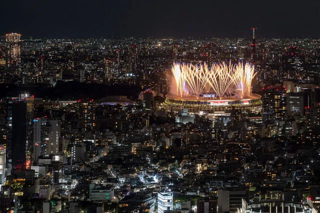 Fireworks light up the sky over the Olympic Stadium during the opening ceremony of the Tokyo 2020 Olympic Games, in Tokyo, on July 23, 2021. (Photo by Charly Triballeau/AFP Photo)