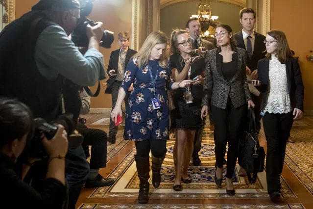 Rep. Alexandria Ocasio-Cortez, D-N.Y., third from right, speaks to reporters as she walks out of the Senate Chamber following two failed votes on ending the partial government shutdown on Capitol Hill in Washington, Thursday, Jan. 24, 2019. (Photo by Andrew Harnik/AP Photo)