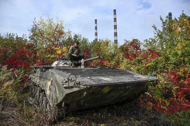 A Ukrainian serviceman sits atop a BMP infantry fighting vehicle in Kramatorsk, eastern Ukraine, on October 2, 2022, amid the Russian invasion of Ukraine. (Photo by Juan Barreto/AFP Photo)