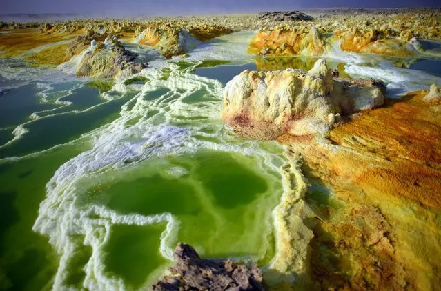 A sulphur lake is pictured in the Danakil Depression on January 23, 2017 near Dallol, Ethiopia. The depression lies 100 metres below sea level and is one of the hottest and most inhospitable places on Earth. Despite the gruelling conditions, Ethiopians continue a centuries old industry of mining salt from the ground by hand in temperatures that average 34.5 degrees centigrade but have risen to over 50 degrees. (Photo by Carl Court/Getty Images)