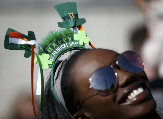 A woman joins in the celebrations during a St. Patrick's Day party and concert in Trafalgar square in central London, Britain March 13, 2016. (Photo by Peter Nicholls/Reuters)
