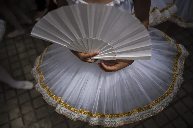 Classic dancers perform on the street during Dance Day, in Pamplona northern Spain, Saturday, April 25, 2015. (Photo by Alvaro Barrientos/AP Photo)