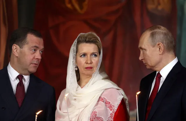 Russia's President Vladimir Putin, Prime Minister Dmitry Medvedev and his wife Svetlana attend the Orthodox Easter service at the Cathedral of Christ the Saviour in Moscow, Russia on April 28, 2019. (Photo by Evgenia Novozhenina/Reuters)