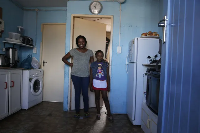 Thozama Kala, 30, and her daughter Mpho, 9, pose for a photograph in the kitchen of their home in Cape Town's Langa township February 8, 2014. Thozama is studying office management after matriculating in 2002. She hopes that her daughter will become a doctor. Mpho says she wants to be a teacher. (Photo by Mike Hutchings/Reuters)