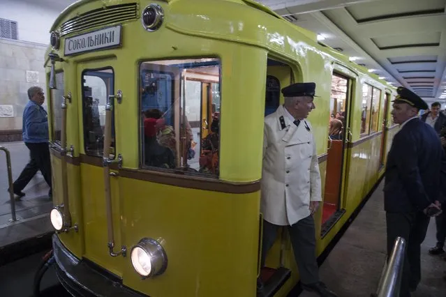Moscow metro train driver dressed in Soviet-era uniforms, stand in the vintage subway car parked in the Partizanskaya subway station in Moscow, Russia, Friday, May 15, 2015. (Photo by Pavel Golovkin/AP Photo)