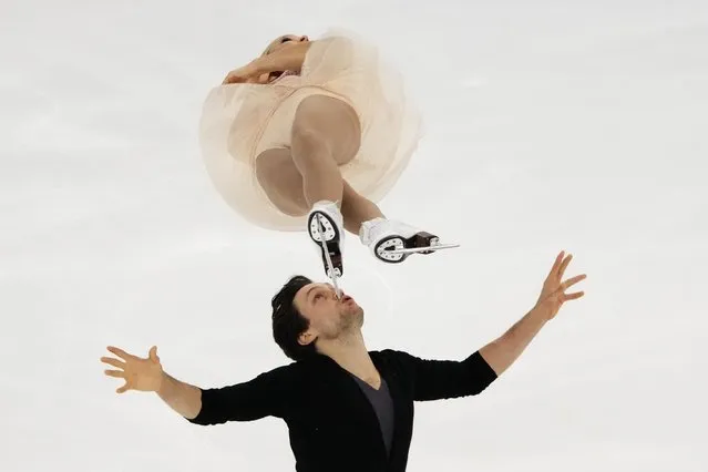 Canada's Kirsten Moore-Towers and Michael Marinaro perform their pairs free skating routine during the ISU Grand Prix of Figure Skating Rostelecom Cup in Sochi, Russia, Saturday, November 27, 2021. (Photo by Alexander Zemlianichenko/AP Photo)