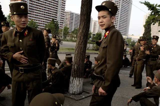 A group of soldiers wait at a bus stop. It is estimated that North Korea has the fourth largest army in the world with 1.21 million soldiers. If the number is correct, it means one in 25 North Koreans is employed by the military. It is not allowed to photograph the military in North Korea. The photo was taken in hiding with a small camera under one of the few walks, we were allowed to make in the capital. (Photo by Peter Hove Olesen)