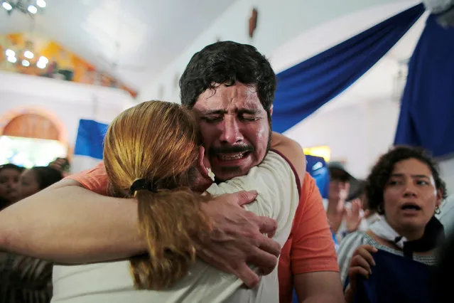 Cristian Fajardo, who according to local media was arrested for participating in a protest against Nicaraguan President Daniel Ortega's government, is embraced by a woman during a religious service after his release, in Masaya, Nicaragua on June 12, 2019. (Photo by Oswaldo Rivas/Reuters)