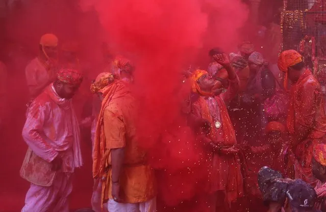 Hindu men from the village of Nandgaon celebrate covered with colored powder the Lathmar Holi festival at the Radha Rani temple in Barsana village, Mathura, India, 06 March 2017. (Photo by Rajat Gupta/EPA)