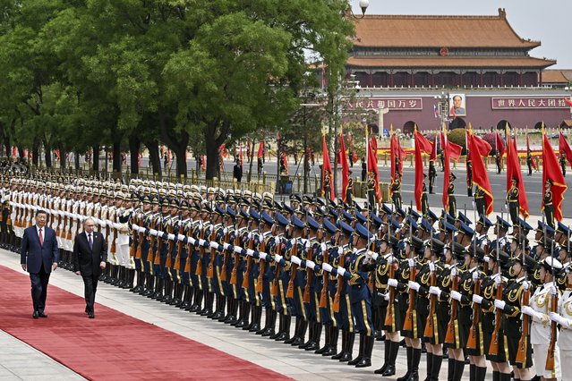 Chinese President Xi Jinping, left, and Russian President Vladimir Putin review the honor guard during an official welcome ceremony in Beijing, China, Thursday, May 16, 2024. (Photo by Sergei Bobylev/Sputnik, Kremlin Pool Photo via AP Photo)