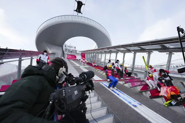 Timi Zajc, of Slovenia, prepares to jump during a men's normal hill ski jumping training session at the 2022 Winter Olympics, Friday, February 4, 2022, in Zhangjiakou, China. (Photo by Matthias Schrader/AP Photo)