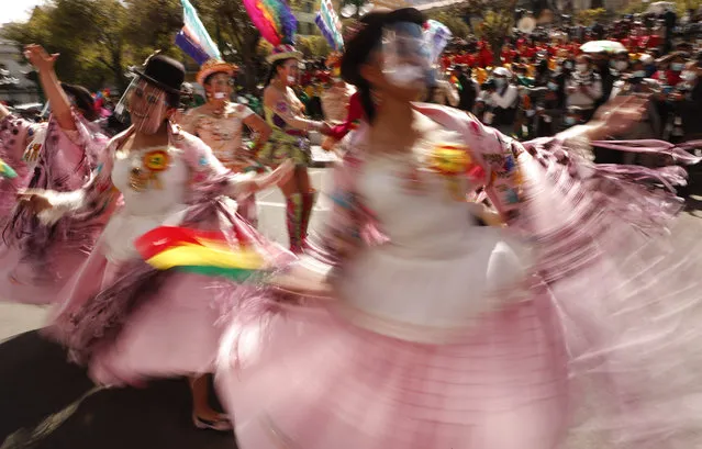 Dancers perform La Morenada, or Dance of the Black Slaves, in Plaza Murillo in La Paz, Bolivia, Tuesday, May 18, 2021. Dancers gathered in defense of the traditional dance they say is part of the Bolivian cultural heritage which was recently claimed by the Peruvian city Puno, causing a diplomatic row. (Photo by Juan Karita/AP Photo)
