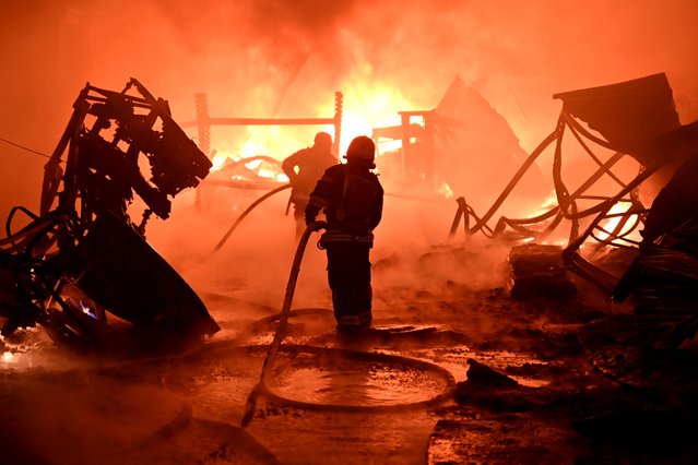 Ukrainian firefighters work to extinguish a fire at the site of a drone attack on industrial facilities in Kharkiv on May 4, 2024, amid the Russian invasion of Ukraine. (Photo by Sergey Bobok/AFP Photo)
