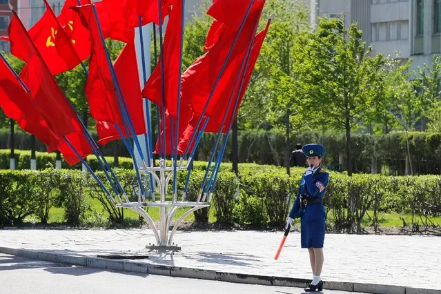 A policewoman controls the traffic in front of Workers' Party of Korea (WPK) flags decorating an intersection in central Pyongyang, North Korea, May 7, 2016. (Photo by Damir Sagolj/Reuters)
