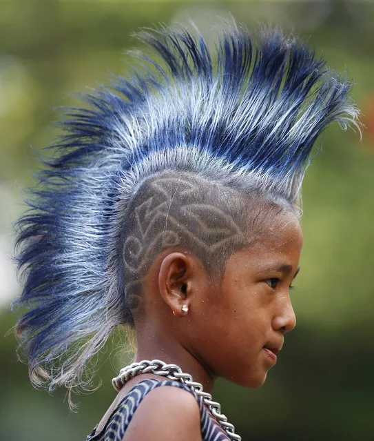 A seven-year-old Myanmar punk wearing a mohawk hairstyle takes part in a punk gathering ahead of the Thingyan water festival in Yangon, Myanmar, 12 April 2017. (Photo by Lynn Bo Bo/EPA)