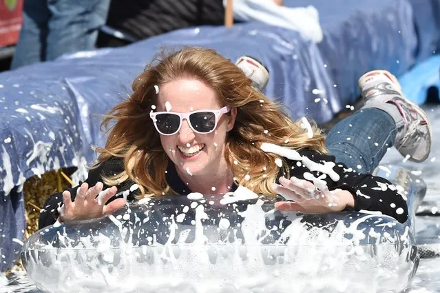 A participant takes part in the Bristol Park and Slide project, an interactive temporary  installation by artist Luke Jerram set up in Park Street in the centre of Bristol, southwest England on May 4, 2014. (Photo by Leon Neal/AFP Photo)