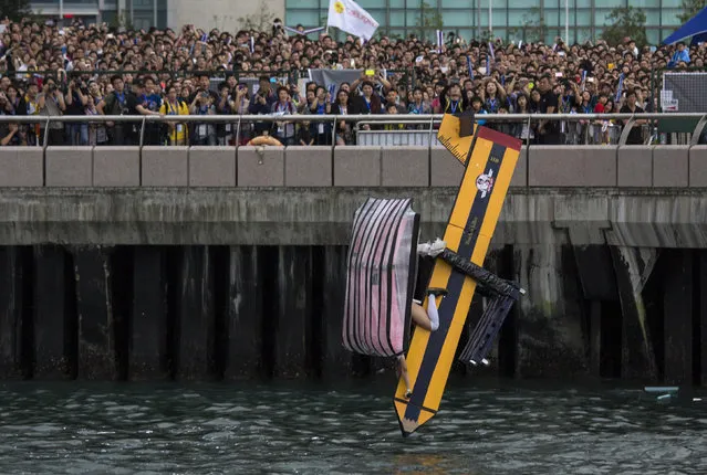 A participant operates “Teacher Killer”, a self-made flying machine, during the Red Bull Flugtag (Flight Day) event at Hong Kong's financial Central district May 11, 2014. Participants from 43 team competed to fly the longest distance in their self-made aircraft in an attempt to win the Flugtag contest. (Photo by Tyrone Siu/Reuters)