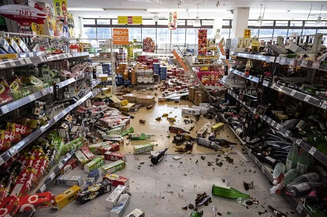 This picture shows a supermarket littered with merchandise in Shiroishi, Miyagi prefecture on March 17, 2022 after a 7.3-magnitude earthquake jolted east Japan the night before. (Photo by Charly Triballeau/AFP Photo)