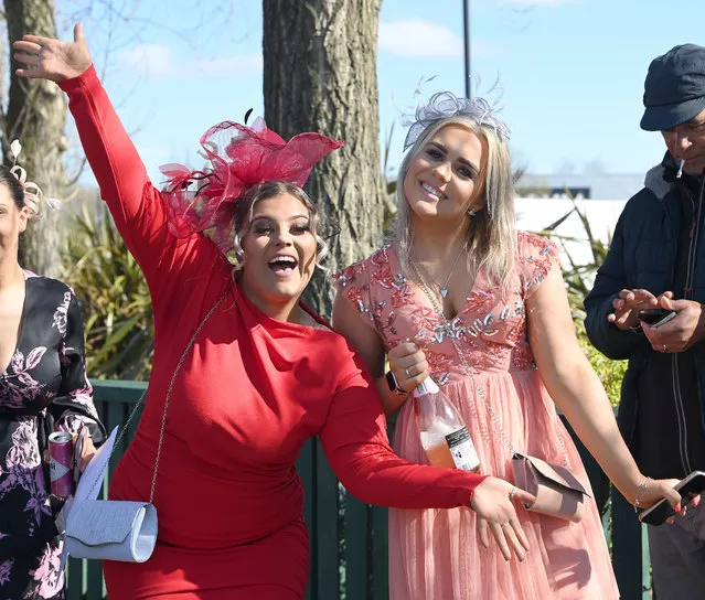 Racegoers pose for photographs at Ladies Day at Aintree Racecourse, Liverpool on Friday, April 8, 2022. (Photo by Dave Nelson/PA Wire Press Association)
