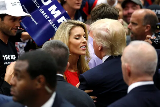 Republican U.S. presidential candidate Donald Trump (2nd R) embraces former Miss California USA Carrie Prejean (C) after a rally with supporters in San Diego, California, U.S. May 27, 2016. Also pictured is Prejean's husband, former NFL quarterback Kyle Boller (L). (Photo by Jonathan Ernst/Reuters)