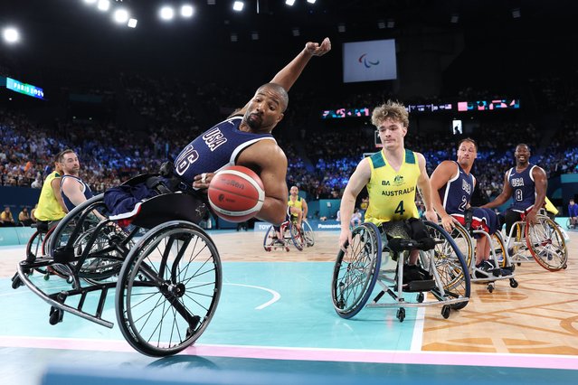 Trevon Jenifer of Team United States falls as Eithen Leard of Team Australia looks on during the Preliminary Round Group B match between Team Australia and Team United States on day four of the Paris 2024 Summer Paralympic Games at Bercy Arena on September 01, 2024 in Paris, France. (Photo by Michael Steele/Getty Images)