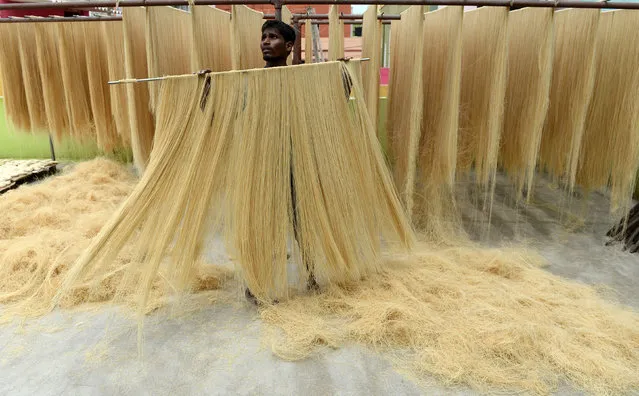 An Indian worker dries thin vermicelli – which is used to make sheerkhorma, a traditional sweet dish prepared during the month of Ramadan – in Chennai on June 15, 2017. Muslims throughout the world are marking the month of Ramadan, the holiest month in the Islamic calendar during which Muslims fast from dawn until dusk. (Photo by Arun Sankar/AFP Photo)
